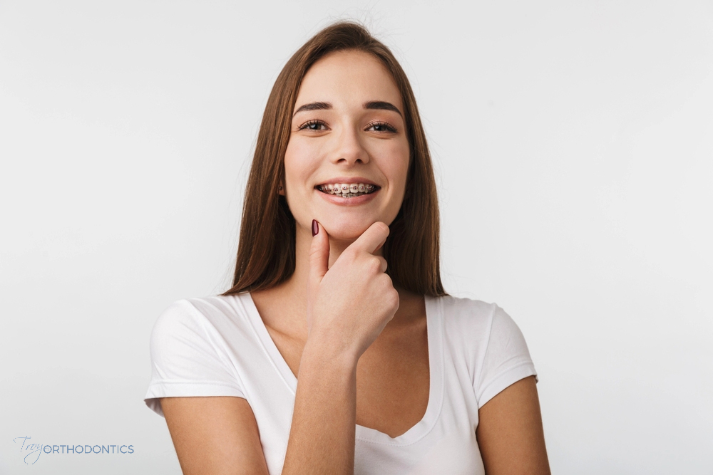 a woman smiling after being explaned about how long do braces take in little falls, nj